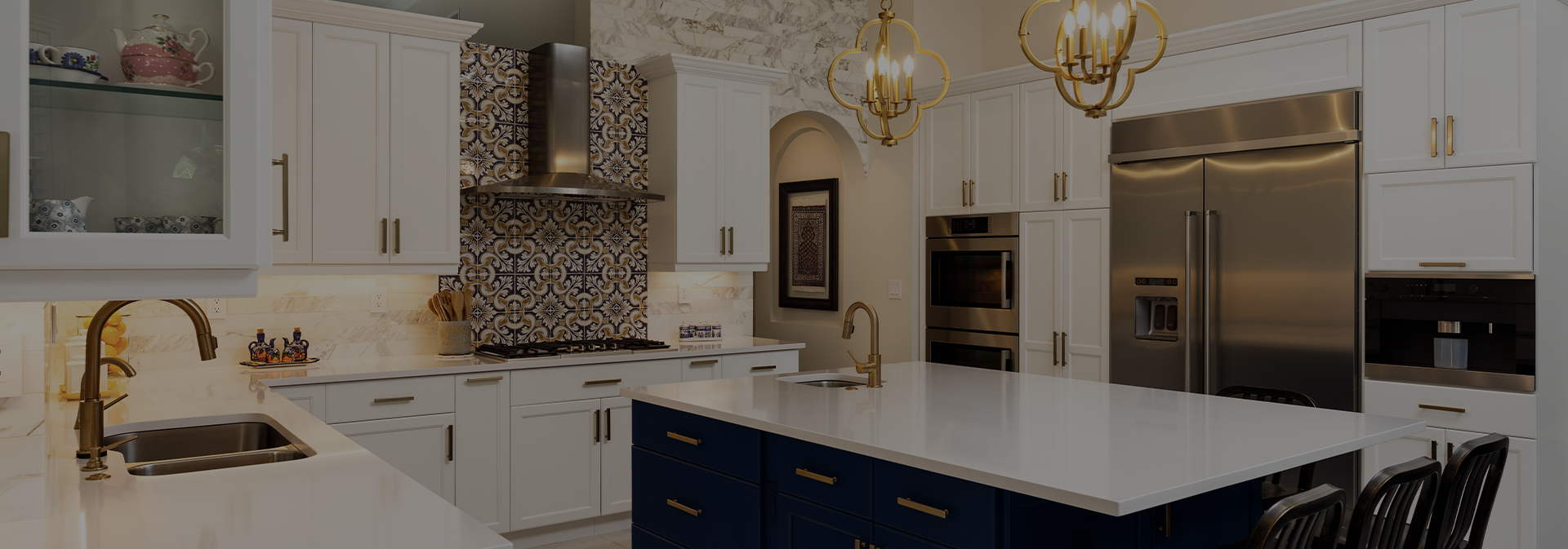 Kitchen redesign with white marble and white cabinets and dark painted island